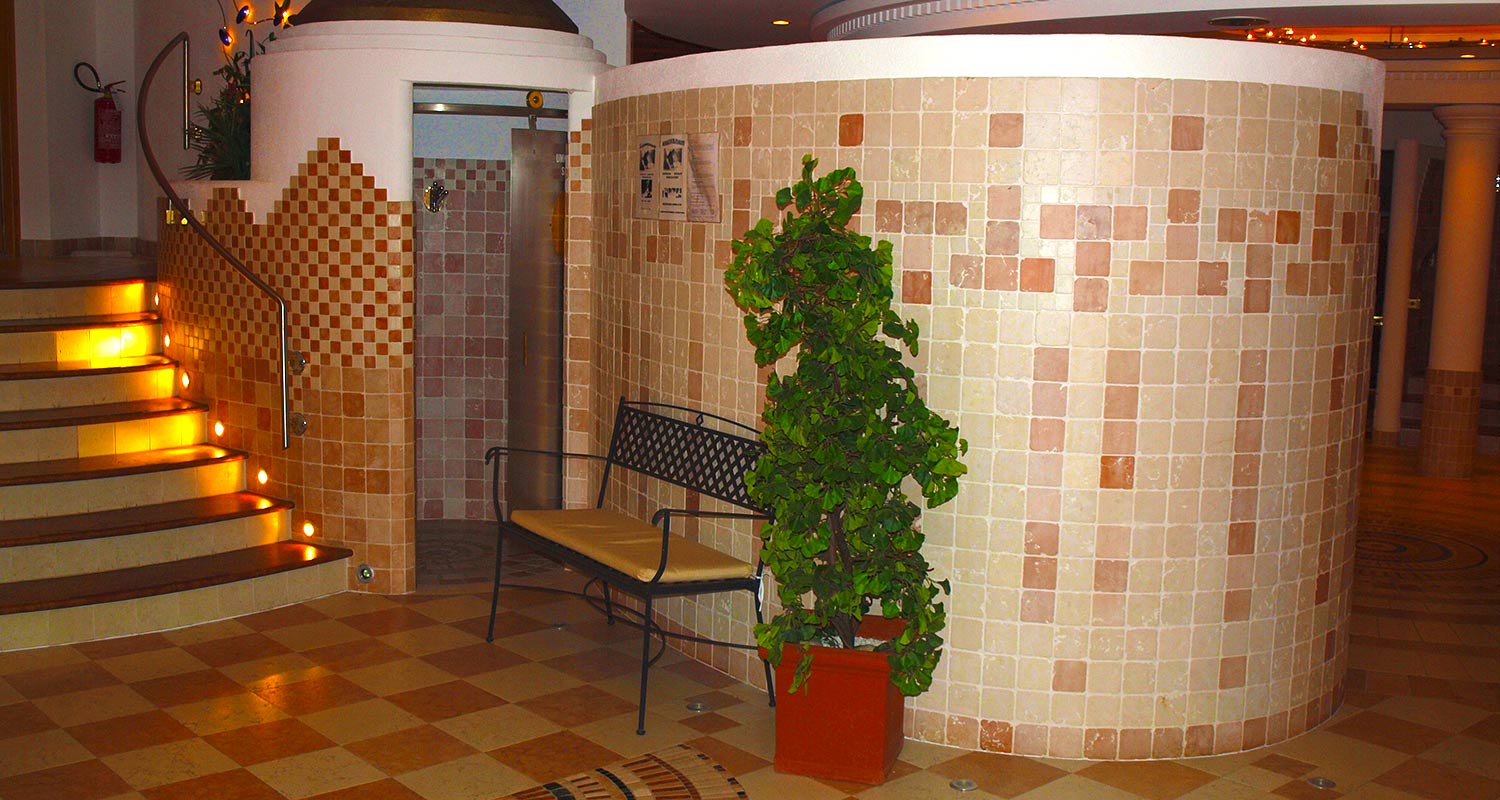 Spa with plant and burning candles on the stairs