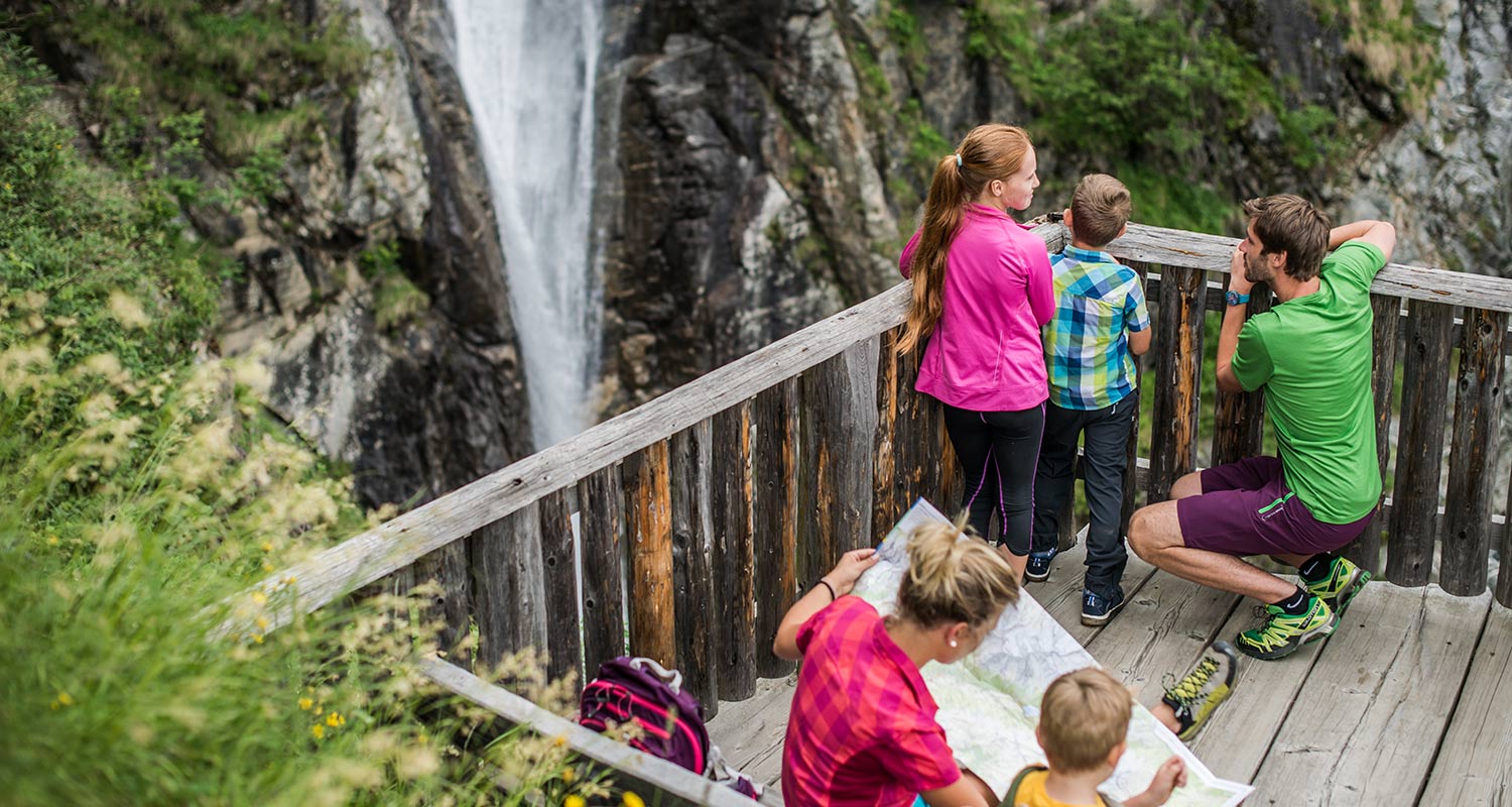 Family during a hike at a waterfall