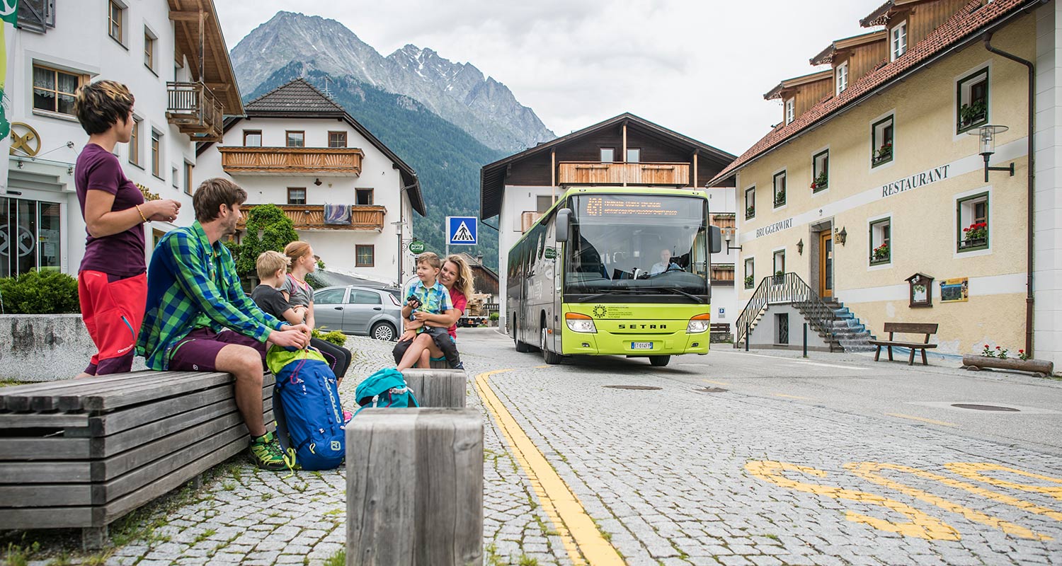 People waiting at a bus stop in Rasen in Antholzertal